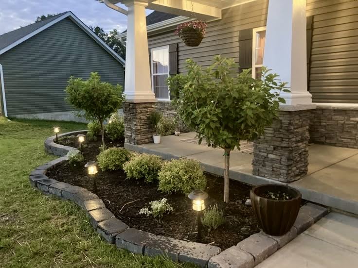 Outdoor landscape lighting illuminating a home exterior
